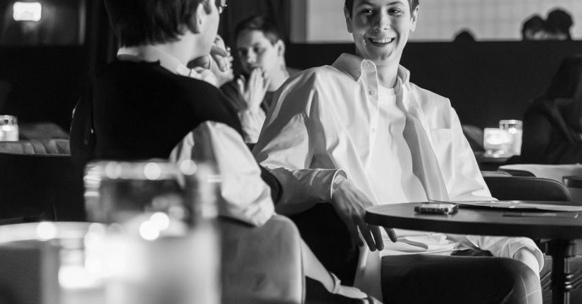 Kid-friendly Table - A black and white photo of two people sitting at a table