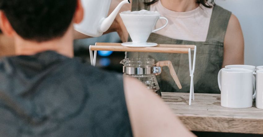 Specialty Coffee - A Woman Pouring Water in the Cup