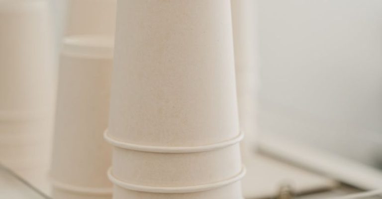 Sustainable Coffee - Set of various white paper cups placed on coffee machine in modern cafe