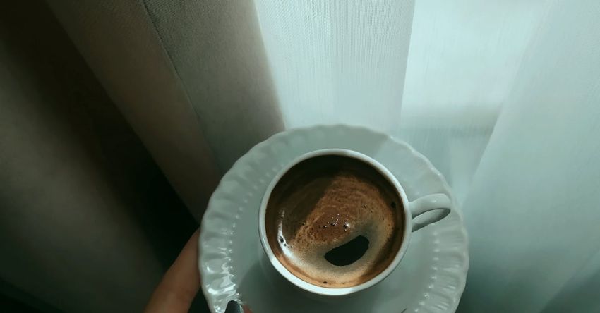 Decaf Coffee - Holding a Porcelain Cup of Coffee on a Saucer