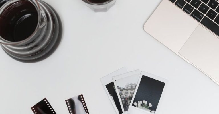 Instant Coffee - Laptop with photographic films and instant photos placed on desk near coffee glass