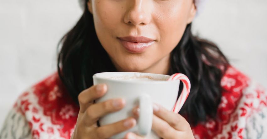 Coffee Festivals - Charming woman in Christmas outfit drinking cup of tasty coffee