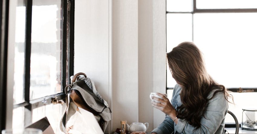 Coffee Shops Remote Work - Woman in Gray Jacket Sitting Beside Desk