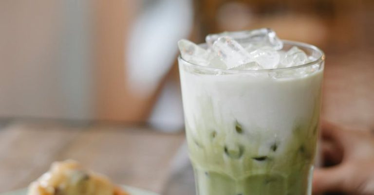 Table Alternatives - Glass of tasty refreshing matcha latte served on table with yummy pie slice in cafe