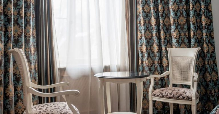 Vintage Table - A room with two chairs and a table in front of a window